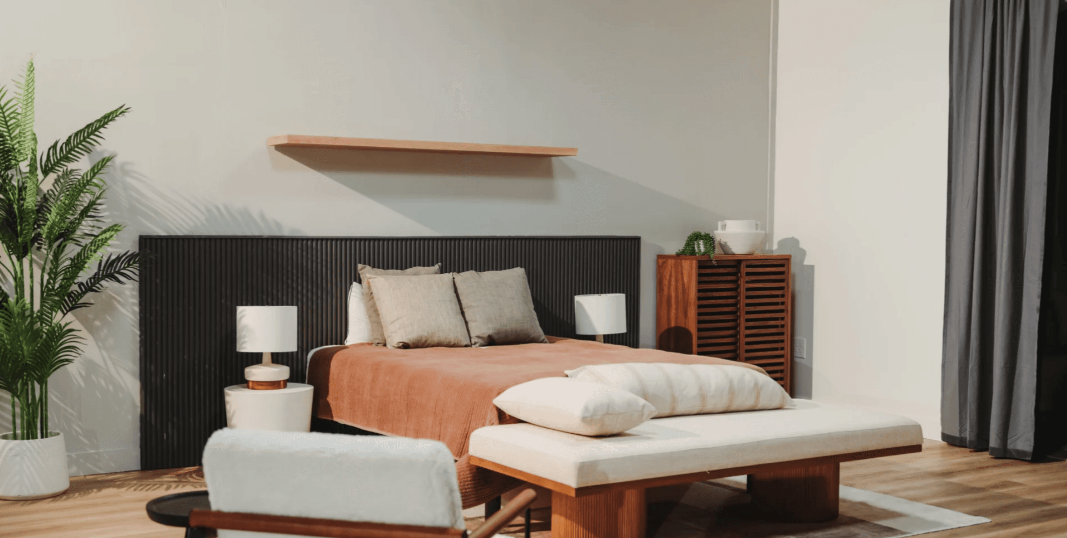 Bedroom set with slatted headboard and terracotta bedding for beauty and fashion photography — Los Angeles studio rental