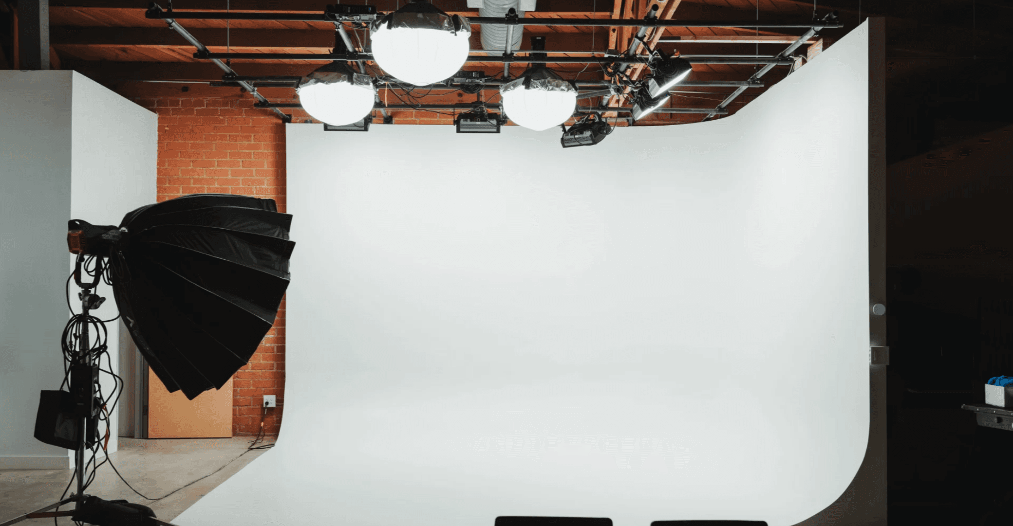 Seamless white cyc wall with overhead grid lighting for e-commerce and editorial photography — Los Angeles studio