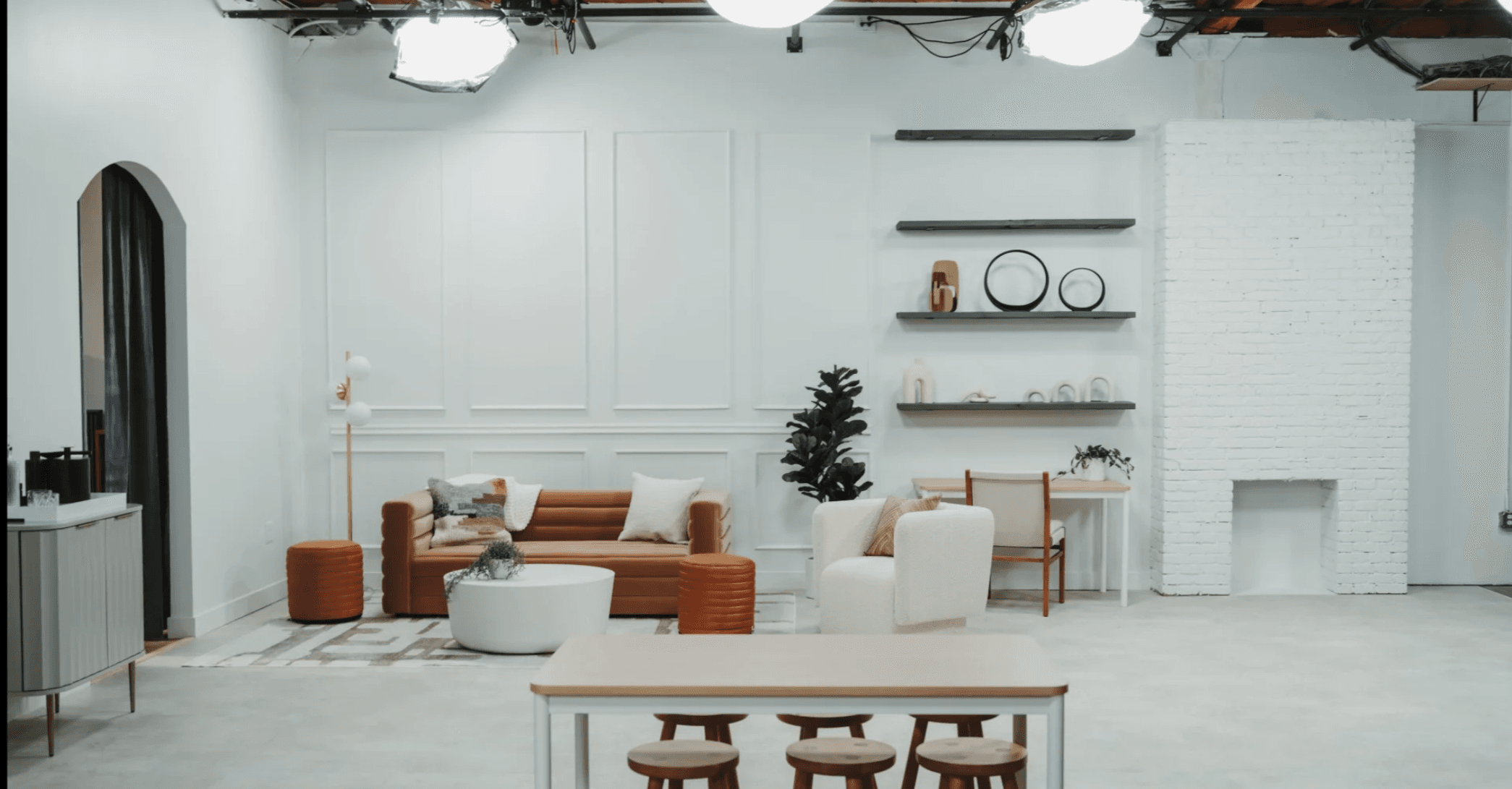 Living room set with French-paneled walls and tan leather sofa — lifestyle and fashion studio rental Los Angeles
